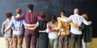 Group of professors standing in front of a blackboard