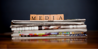 Wooden blocks on a stack of newspapers