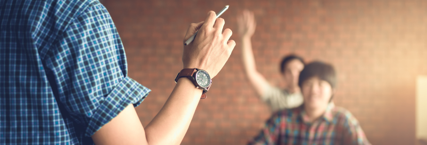 Image of teacher calling on student with their hand raised