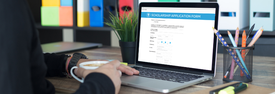Image of student filling out a scholarship application on a laptop